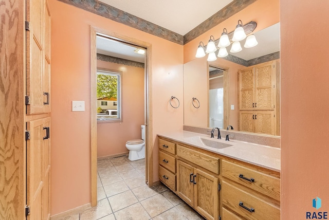 bathroom with tile patterned floors, toilet, baseboards, and vanity