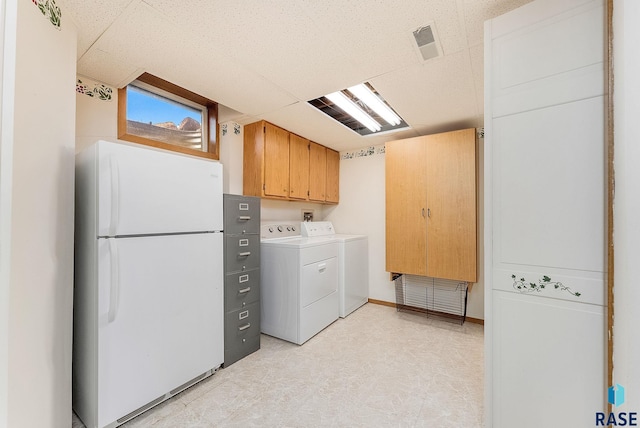laundry area featuring light floors, cabinet space, independent washer and dryer, and visible vents
