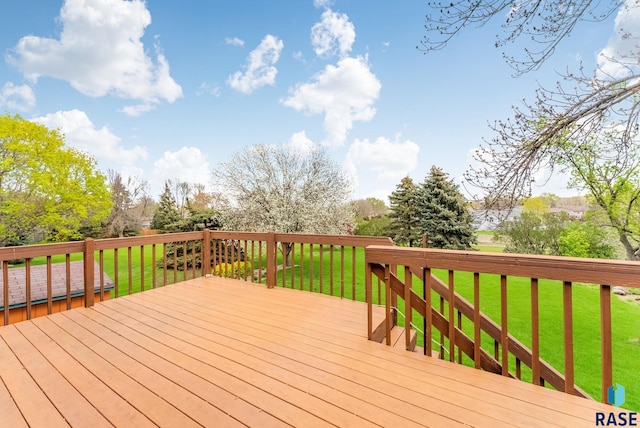 wooden deck with a lawn