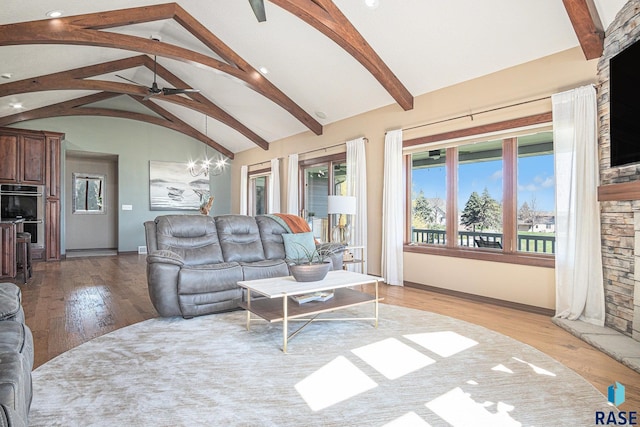 6601 Lenola Hts, Wentworth, SD 57075 - living room with ceiling fan with notable chandelier, lofted ceiling with beams, baseboards, light wood-style floors, and recessed lighting