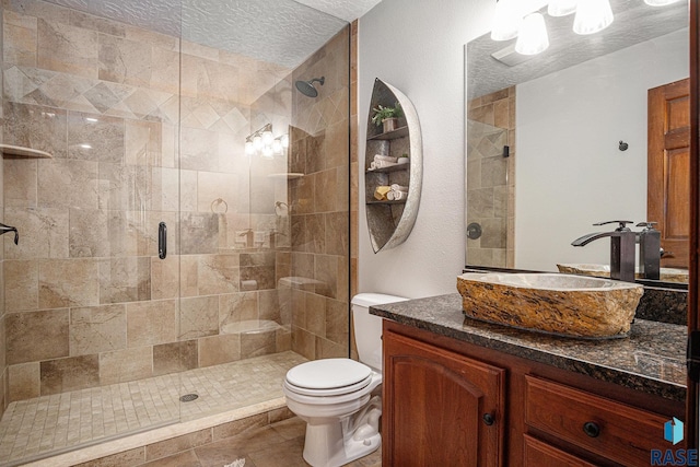 6601 Lenola Hts, Wentworth, SD 57075 - bathroom featuring a stall shower, vanity, toilet, and a textured ceiling