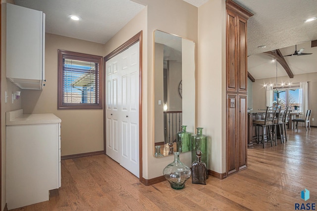 6601 Lenola Hts, Wentworth, SD 57075 - corridor featuring lofted ceiling with beams, light wood-type flooring, baseboards, a chandelier, and recessed lighting