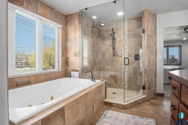 6601 Lenola Hts, Wentworth, SD 57075 - full bathroom with a shower stall, a wealth of natural light, a jetted tub, and a textured ceiling