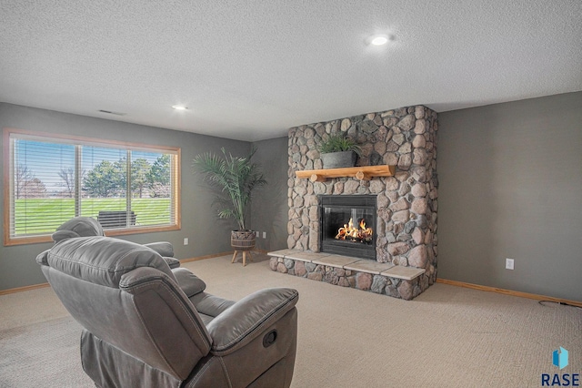 6601 Lenola Hts, Wentworth, SD 57075 - carpeted living room featuring a textured ceiling, a fireplace, and baseboards