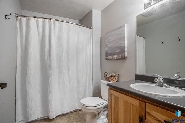 6601 Lenola Hts, Wentworth, SD 57075 - full bathroom featuring toilet, vanity, a textured ceiling, visible vents, and tile patterned flooring