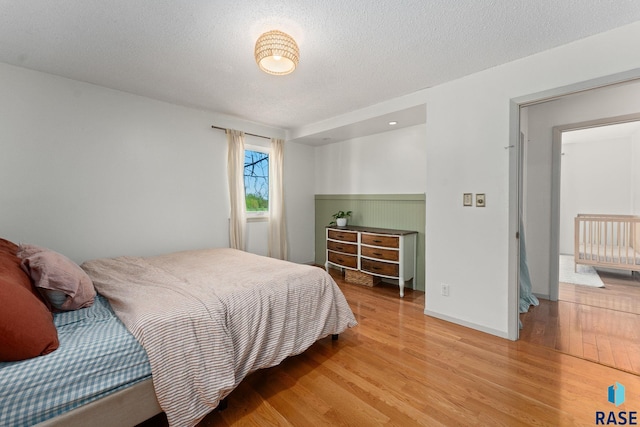 20395 Northgrove Loop, Brookings, SD 57006 - bedroom featuring light wood-style floors and a textured ceiling