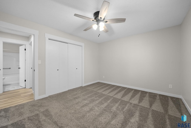 unfurnished bedroom featuring carpet flooring, baseboards, and a closet