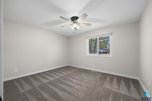 spare room featuring carpet flooring, baseboards, and ceiling fan