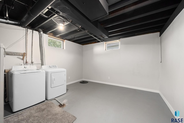 basement featuring washing machine and clothes dryer and visible vents