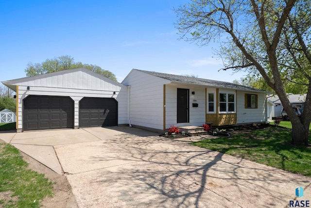 single story home with an outdoor structure and driveway