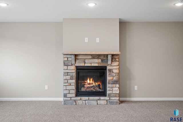 interior details with carpet flooring, baseboards, a stone fireplace, and recessed lighting
