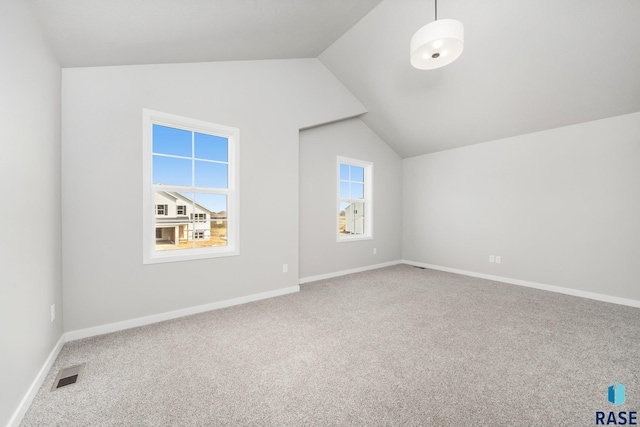 bonus room featuring lofted ceiling, carpet, visible vents, and a wealth of natural light