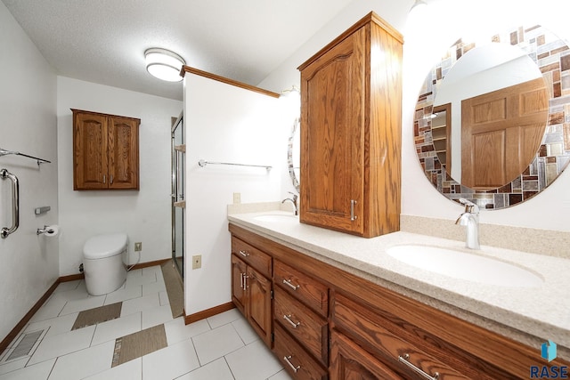 full bathroom with toilet, visible vents, a sink, and a stall shower