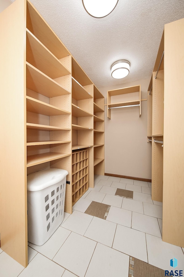 spacious closet with light tile patterned flooring
