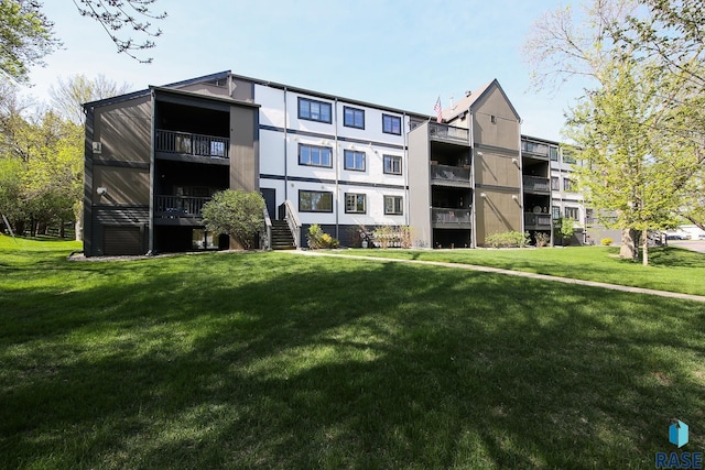 view of apartment building / complex featuring stairway