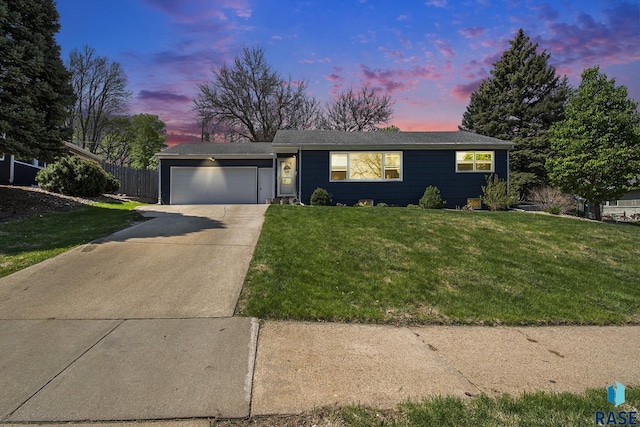 single story home with a yard, fence, an attached garage, and driveway