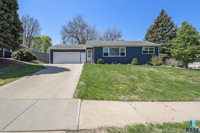 ranch-style home with driveway, a garage, fence, and a front yard