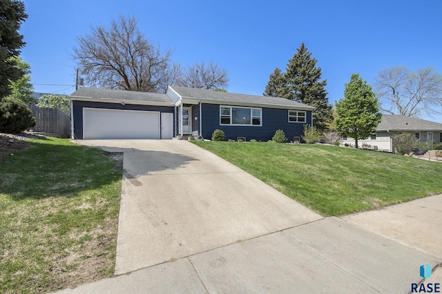 ranch-style home featuring concrete driveway, a garage, fence, and a front yard