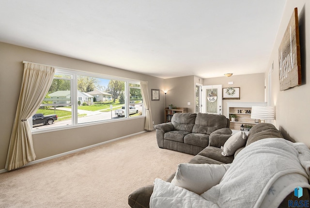 living area with light colored carpet and baseboards