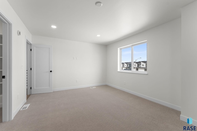unfurnished bedroom featuring baseboards, carpet flooring, visible vents, and recessed lighting