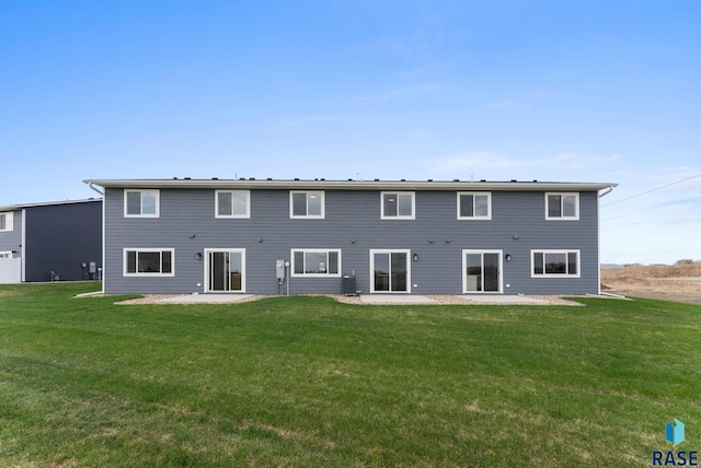 back of house featuring a yard and a patio