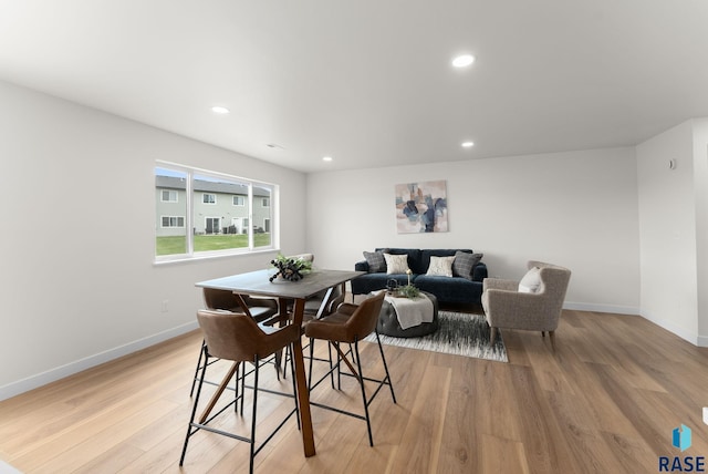 dining area featuring light wood-type flooring, baseboards, and recessed lighting