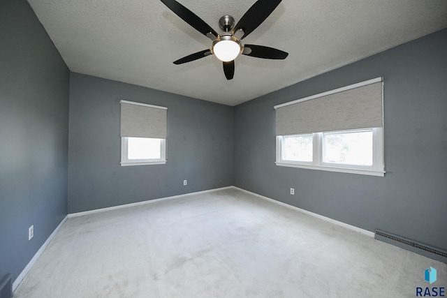 420 S Mary Ave, Tea, SD 57064 - empty room featuring a ceiling fan, healthy amount of natural light, carpet, baseboards, and a textured ceiling