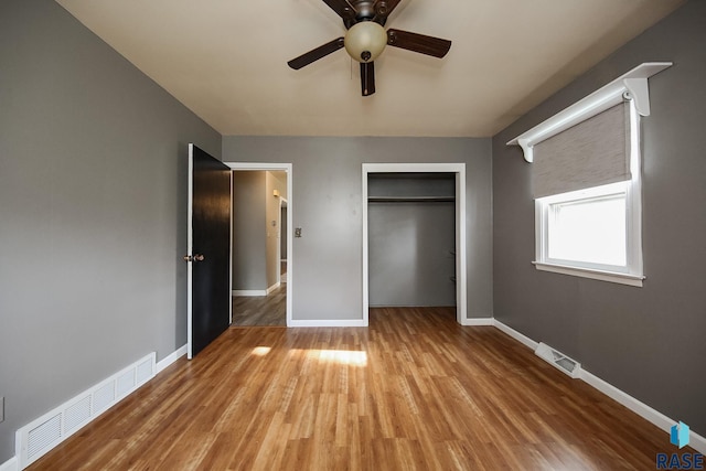 420 S Mary Ave, Tea, SD 57064 - unfurnished bedroom featuring baseboards, wood finished floors, a closet, and a ceiling fan