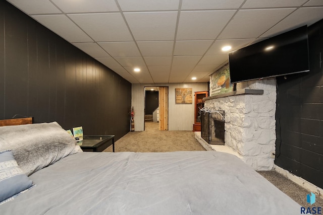 420 S Mary Ave, Tea, SD 57064 - bedroom featuring carpet flooring, a drop ceiling, a stone fireplace, wooden walls, and recessed lighting