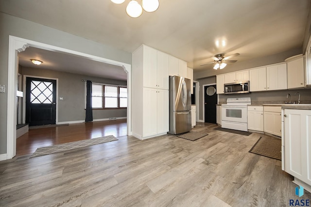 420 S Mary Ave, Tea, SD 57064 - kitchen with appliances with stainless steel finishes, a ceiling fan, white cabinetry, and baseboards