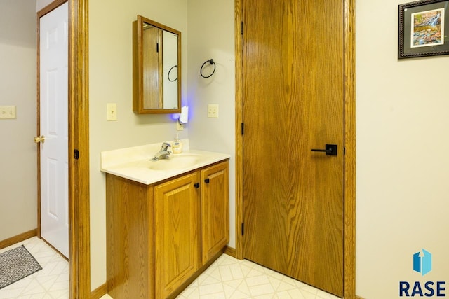 bathroom featuring vanity, tile patterned floors, and baseboards