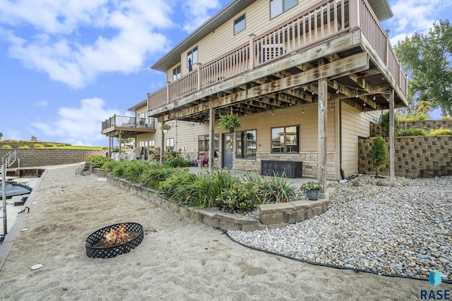 6014 Marrs Beach Ln, Madison, SD 57042 - rear view of property featuring a fire pit, a deck, a patio area, and fence