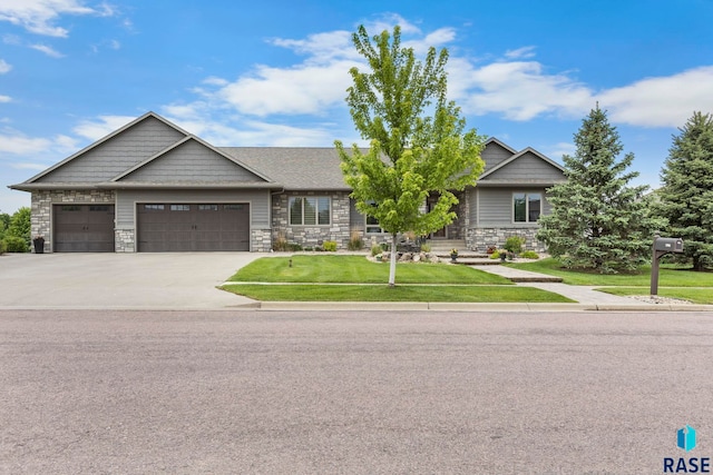 2708 W Bitterroot St, Sioux Falls, SD 57108 - view of front of property with an attached garage, stone siding, a front yard, and driveway