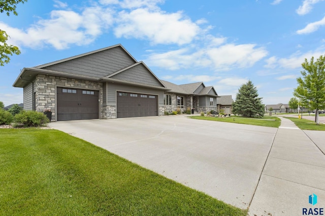 2708 W Bitterroot St, Sioux Falls, SD 57108 - craftsman-style home with a front lawn, an attached garage, stone siding, and concrete driveway