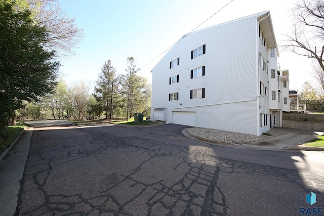 view of building exterior featuring asphalt driveway