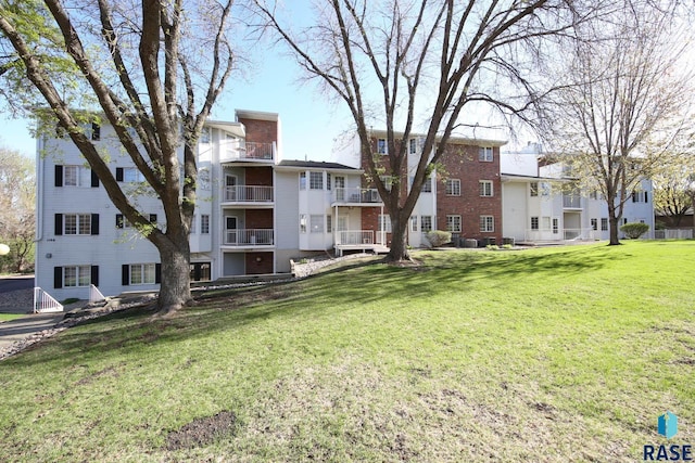 view of home's community with a yard and a residential view