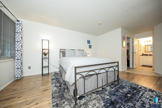 bedroom with light wood-style flooring and baseboards