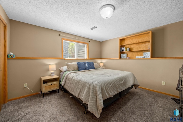 carpeted bedroom featuring baseboards and a textured ceiling
