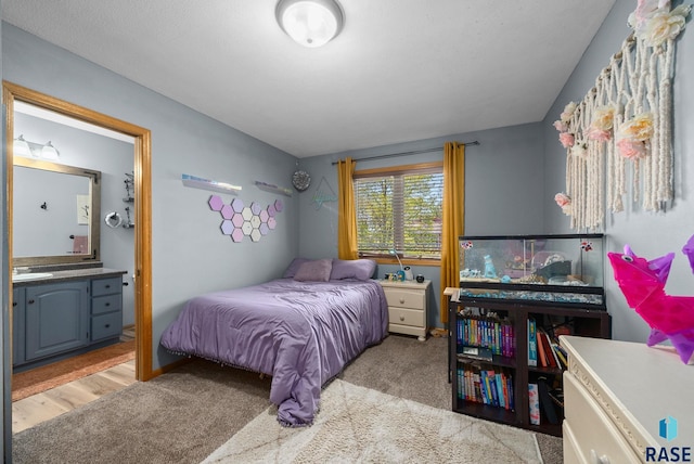 carpeted bedroom with ensuite bathroom