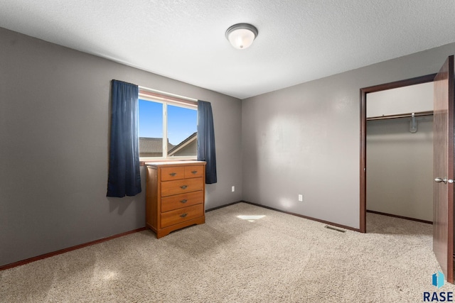925 E Steep St, Tea, SD 57064 - unfurnished bedroom featuring baseboards, a closet, a textured ceiling, light colored carpet, and a spacious closet