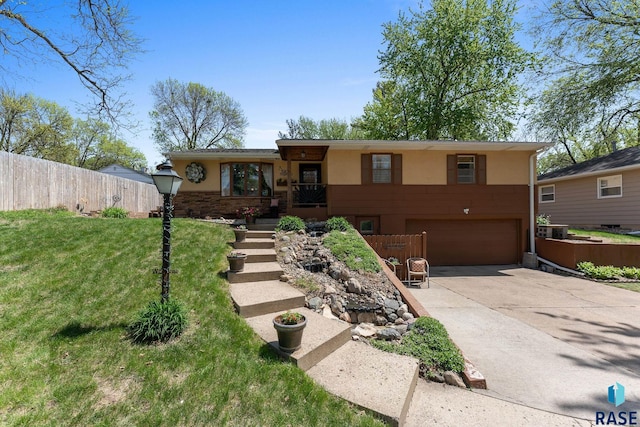 ranch-style home featuring an attached garage, concrete driveway, and stucco siding