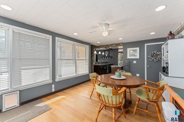 dining room featuring a ceiling fan, light wood finished floors, baseboards, and recessed lighting