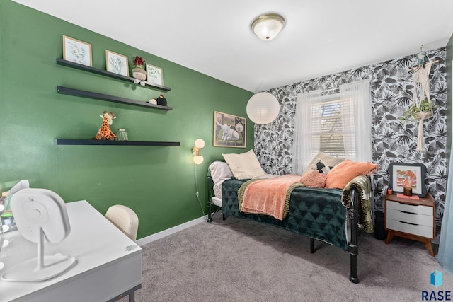 bedroom featuring carpet, wallpapered walls, baseboards, and an accent wall
