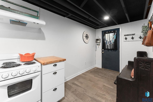 kitchen featuring white electric range, range hood, white cabinetry, wood finished floors, and baseboards