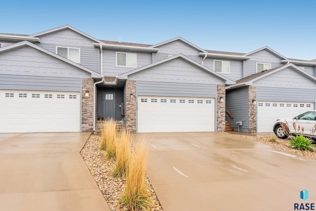 4243 N Knob Hill Ct, Sioux Falls, SD 57107 - multi unit property featuring driveway, an attached garage, and stone siding