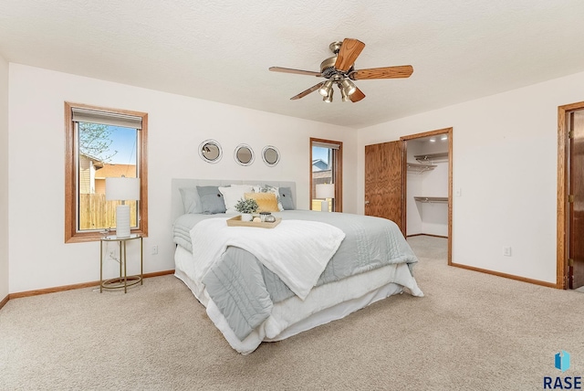 110 W Apple St, Tea, SD 57064 - bedroom featuring carpet floors, baseboards, ceiling fan, a walk in closet, and a closet