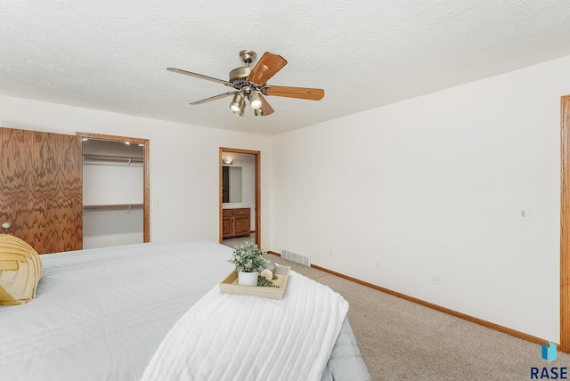 110 W Apple St, Tea, SD 57064 - carpeted bedroom with baseboards, ceiling fan, a walk in closet, connected bathroom, and a closet