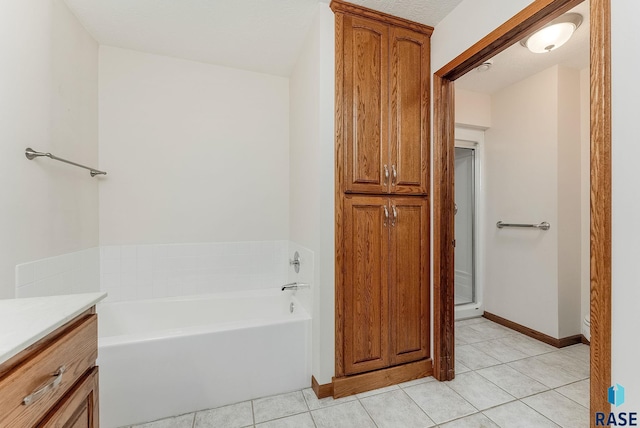110 W Apple St, Tea, SD 57064 - bathroom with tile patterned flooring, a garden tub, baseboards, and vanity