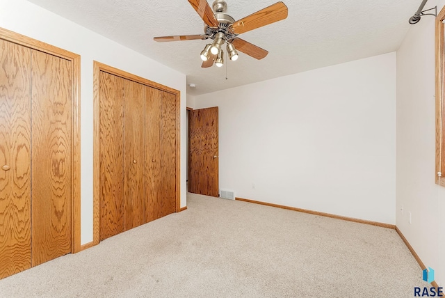 110 W Apple St, Tea, SD 57064 - unfurnished bedroom featuring carpet, ceiling fan, two closets, and baseboards