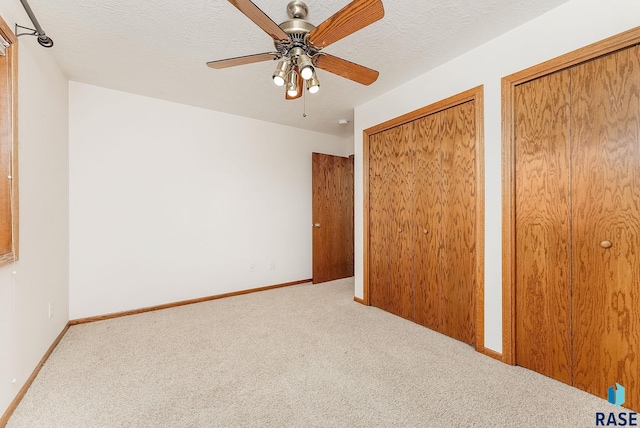 110 W Apple St, Tea, SD 57064 - unfurnished bedroom with carpet, two closets, and baseboards